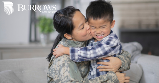 mother in a military uniform kissing her son on the cheek