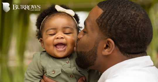 father kissing his daughter on the cheek