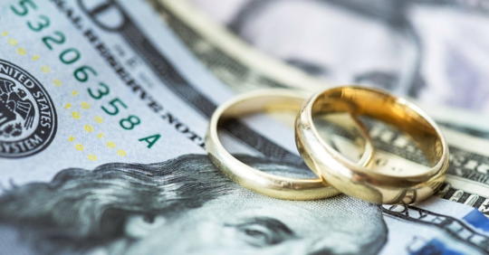 Wedding rings on American dollar bills.