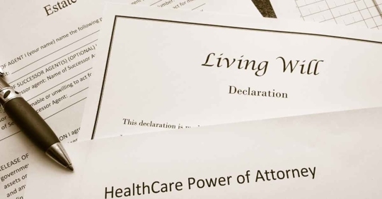 Estate planning documents, including a healthcare power of attorney on top and a living will declaration underneath
