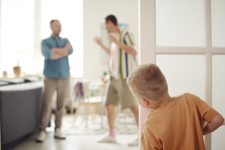young boy watching fathers fight