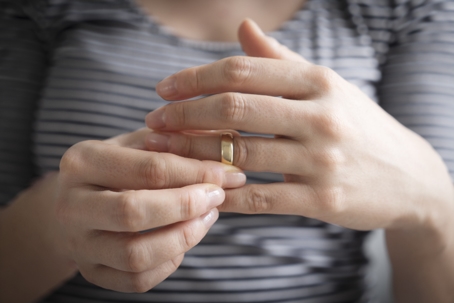 woman taking off wedding ring