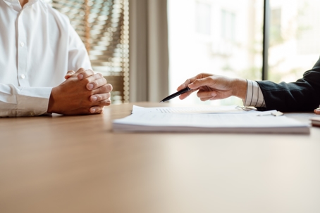 two people reviewing a document in an office