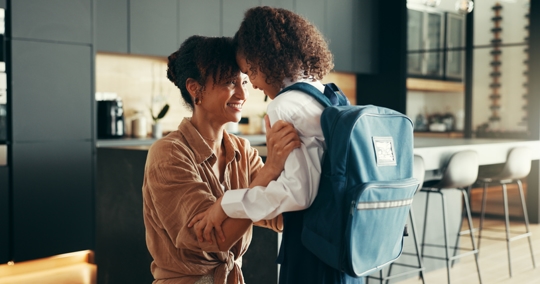 mother saying goodbye to daughter before school