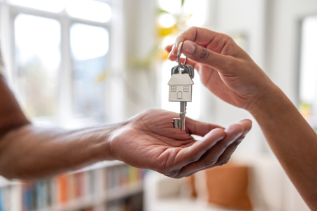 real estate agent handing a man house keys