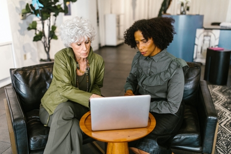 elderly woman sitting with estate planner looking at laptop
